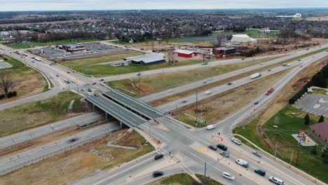 an aerial time lapse of cars driving across a bridge and highway