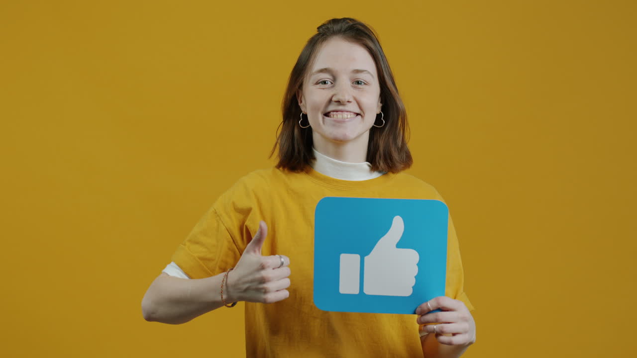 Woman showing thumbs up and holding a blue like icon
