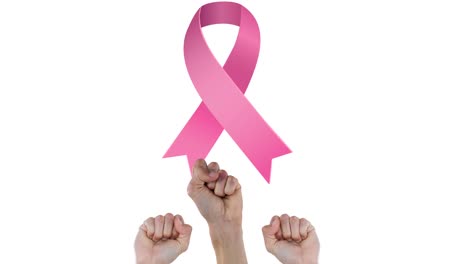 Animation-of-pink-ribbon-logo-over-raised-fists