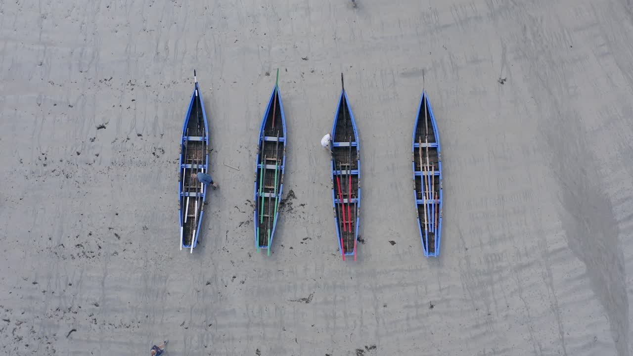Top down bird's eye view descending drone shot above currach irish canoe boats
