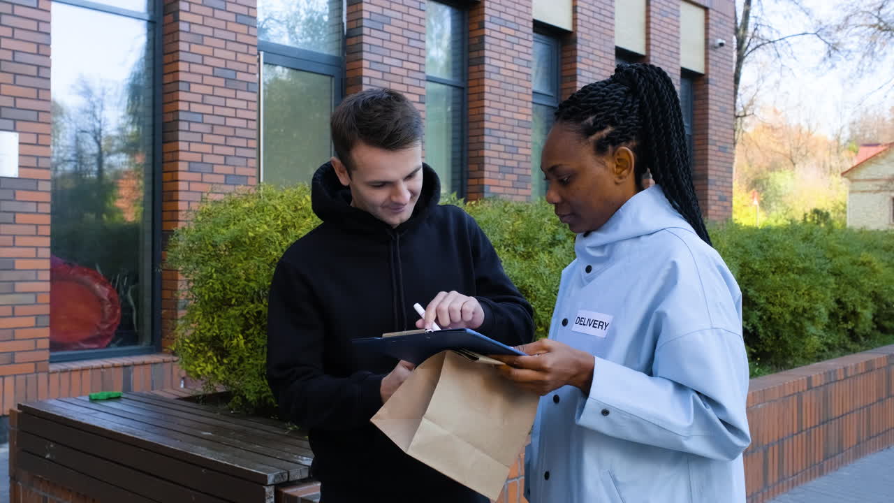 Delivery girl with paper bag and a clipboard