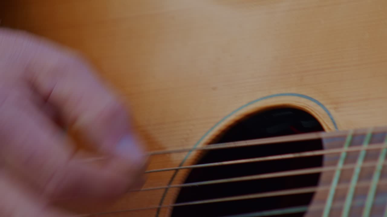 acoustic guitar playing, closeup view of a hand wrist, fingers and strings