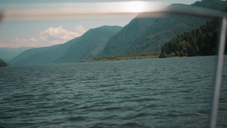 large mountains covered with wild wood on coast view from sailing yacht. gorgeous ridge observing while riding motor boat on holiday cruise