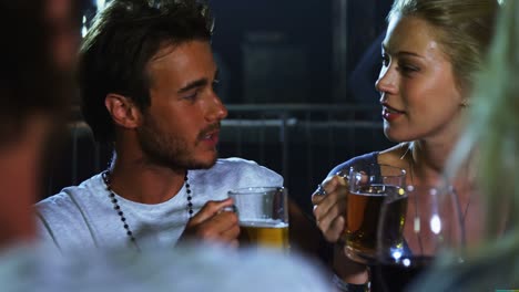 couple having mug of beer at a concert 4k