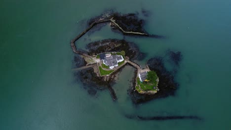 aerial view flying towards swellies ynys gored goch houses on whitebait island welsh flowing menai straits anglesey