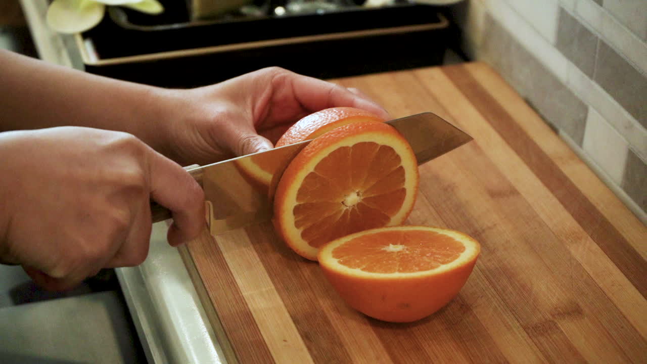 woman slicing an orange at a spa bar