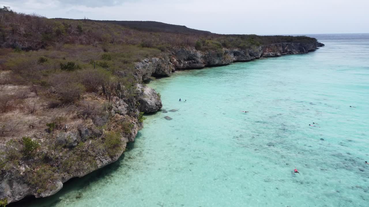 Caribbean Beach with rocky cliff and turquoise water