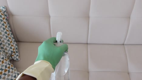 cleaning a sofa with spray bottle