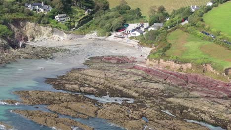 Wide-Aaerial-view-rising-shot-of-Talland-Bay,-on-the-South-West-Coastal-path-between-the-Cornish-Town-of-Looe,-and-village-of-Polperro