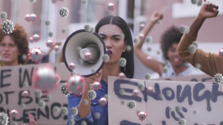 Numerose cellule di Covid-19 che fluttuano davanti a un gruppo di persone diverse che protestano per strada