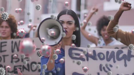 multiple covid-19 cells floating against group of diverse people protesting on the street