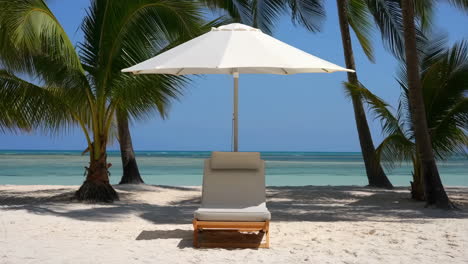 tropical beach scene with lounge chair and umbrella