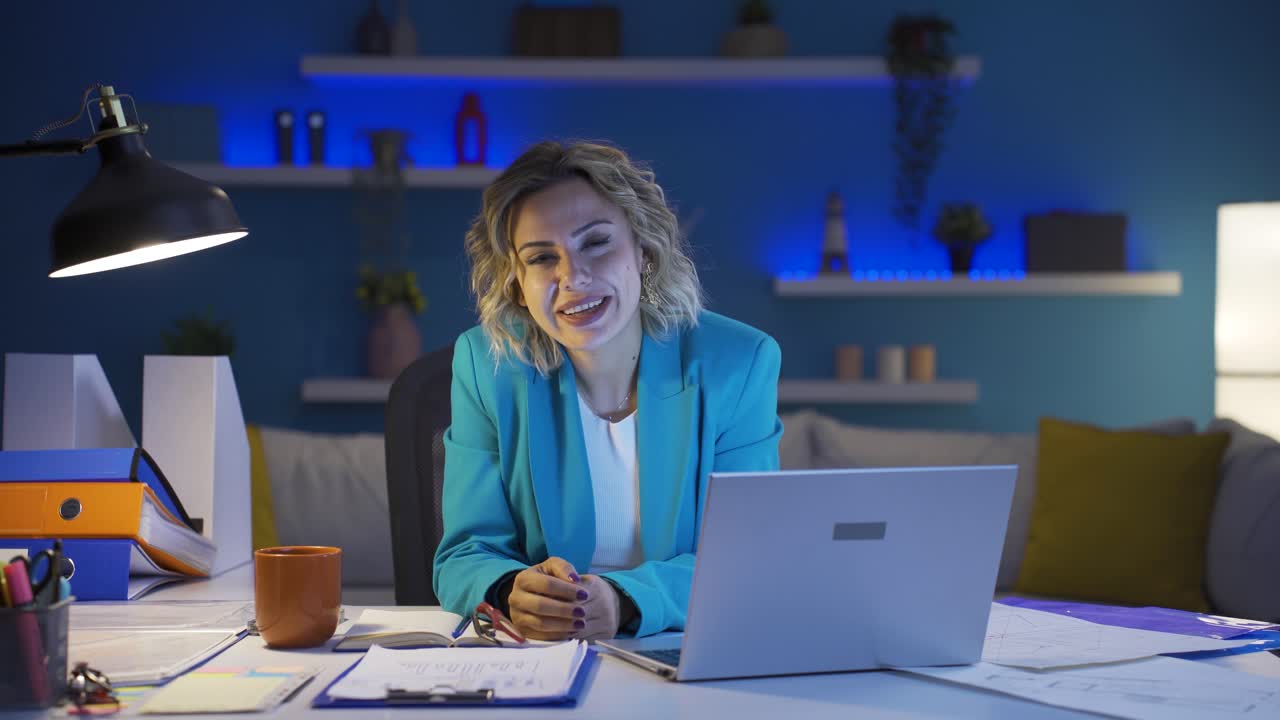 Home office worker woman talking facetime looking at camera.
