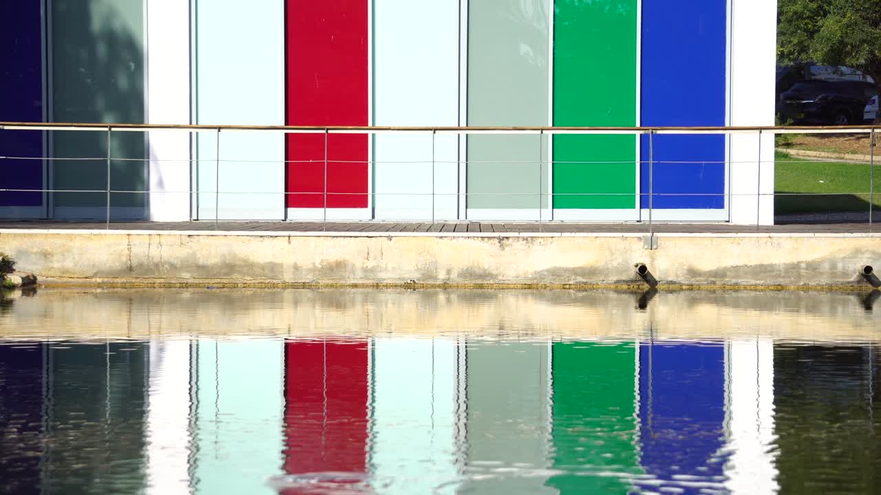 Shot of the lake reflection with near colorful buildings in Almancil, Portugal