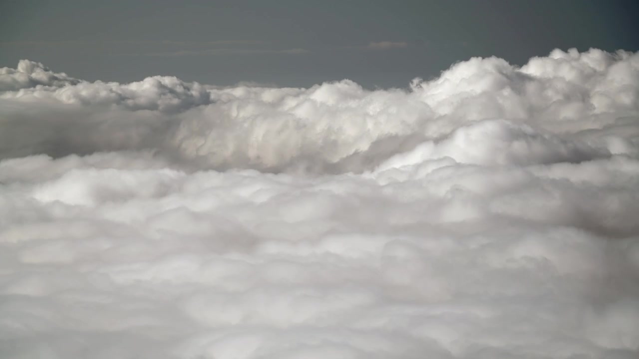 Aerial View of Dense White Clouds Moving Slowly