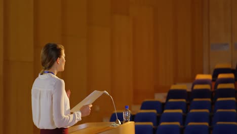 young caucasian businesswoman practicing speech in empty auditorium 4k