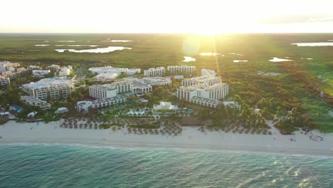 aerial view of playa mujeres resort and suites at sunset in cancun, mexico.