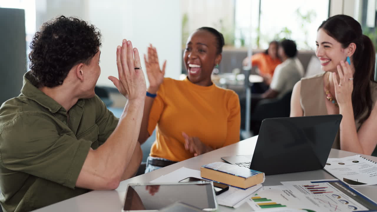 Diverse Business Team Celebrating Success with High Fives in Modern Office