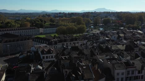 Drone-flying-over-Bayonne-building-roofs,-France