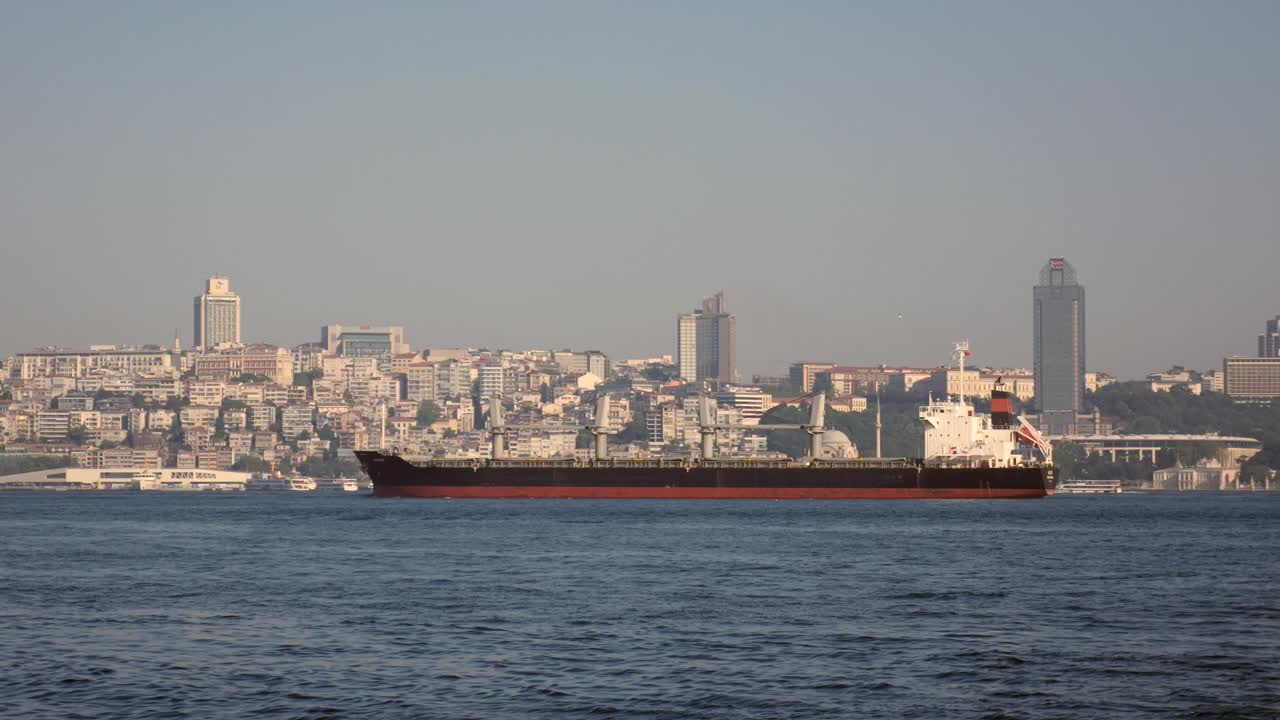 Ship on the sea with cityscape in the background