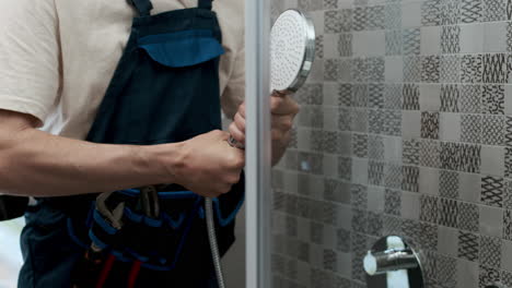 plumber fixing shower head