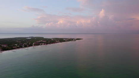 drone shot view of the beach water island with purple sky