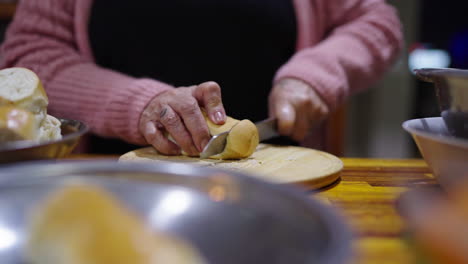 slicing fresh bread to accompany traditional bagna cauda, perfect for dipping.