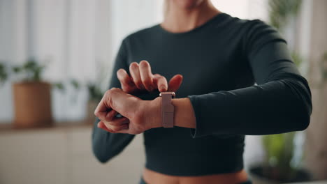 woman checking her smartwatch during workout