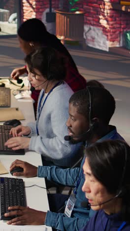 vertical video team of multiethnic call center agents in workplace helping customers