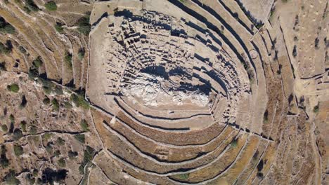 aerial bird's eye video taken by drone of iconic prehistoric settlement of skarkos, ios island, cyclades, greece