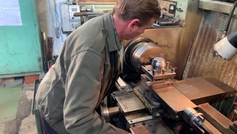 turner behind a turning and milling machine.