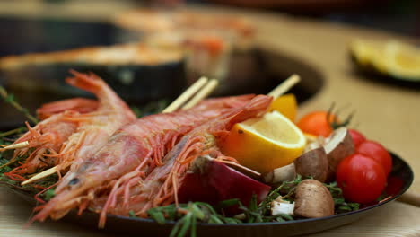 prawns with vegetables served for bbq party. closeup shrimp sticks on plate