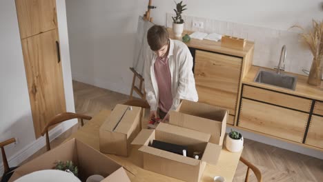 man unpacking boxes in a new home