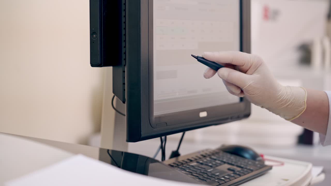 Laboratory worker uses modern device. Medical assistant holding special pen and working on a monitor in clinic. Contemporary equipment in the laboratory.