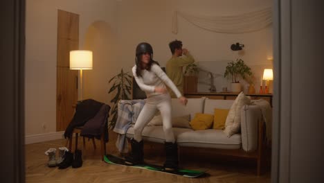woman snowboarding inside at night