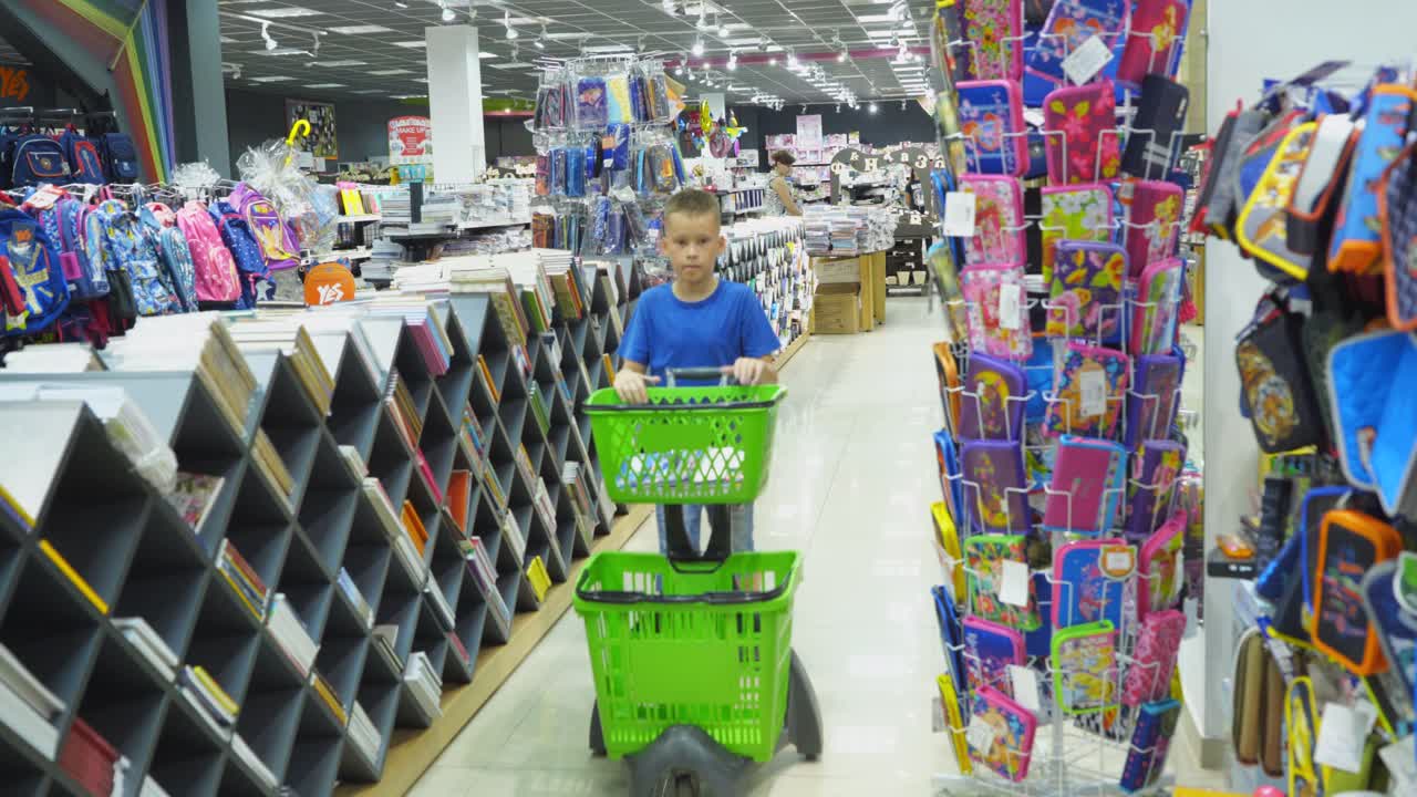 VINNITSA, UKRAINE - AUGUST 20, 2018: Boy choosing school stationery at a supermarket. Back to School