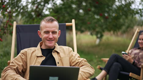 couple working outdoors in an apple orchard