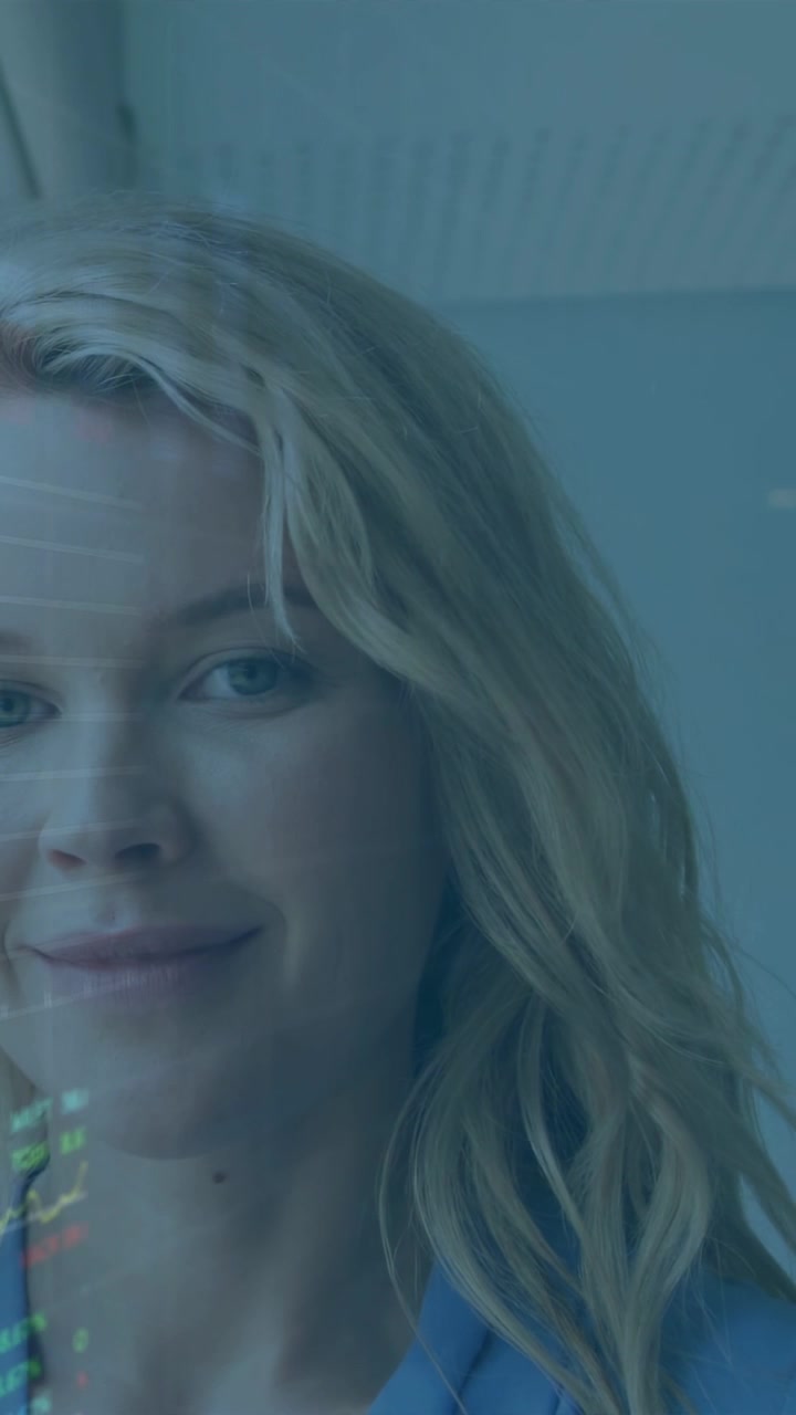 Vertical video: Camera panning woman turning, blinking smiling, data shifting on face showing tech