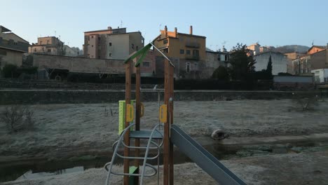 Orbital-shot-of-a-slide-and-other-playground-equipment-with-no-people