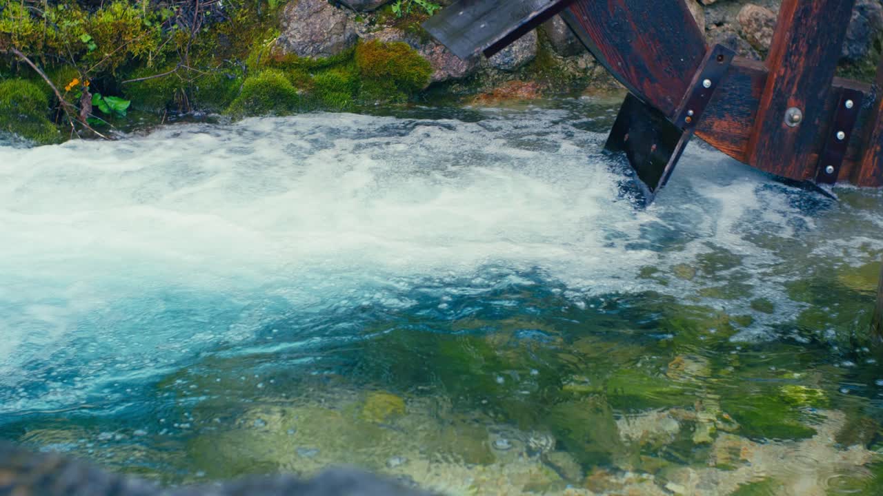 Immerse yourself in the pristine beauty of the Julian Alps with this stunning capture of a mountain river near Kranjska Gora, Slovenia. Crystal-clear turquoise water flows over smooth river rocks.