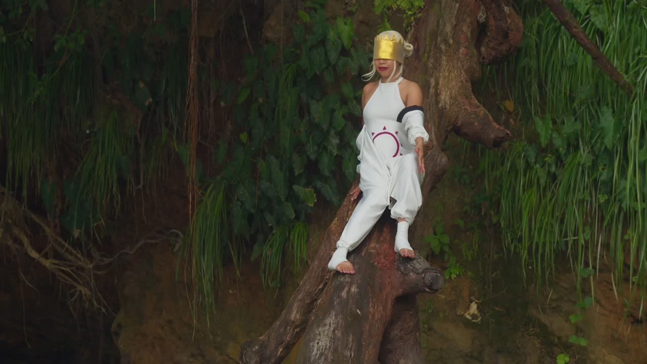 A soft, atmospheric image of a girl in fantasy dress strolling along the shoreline, illuminated by the flat, diffused light of a cloudy day