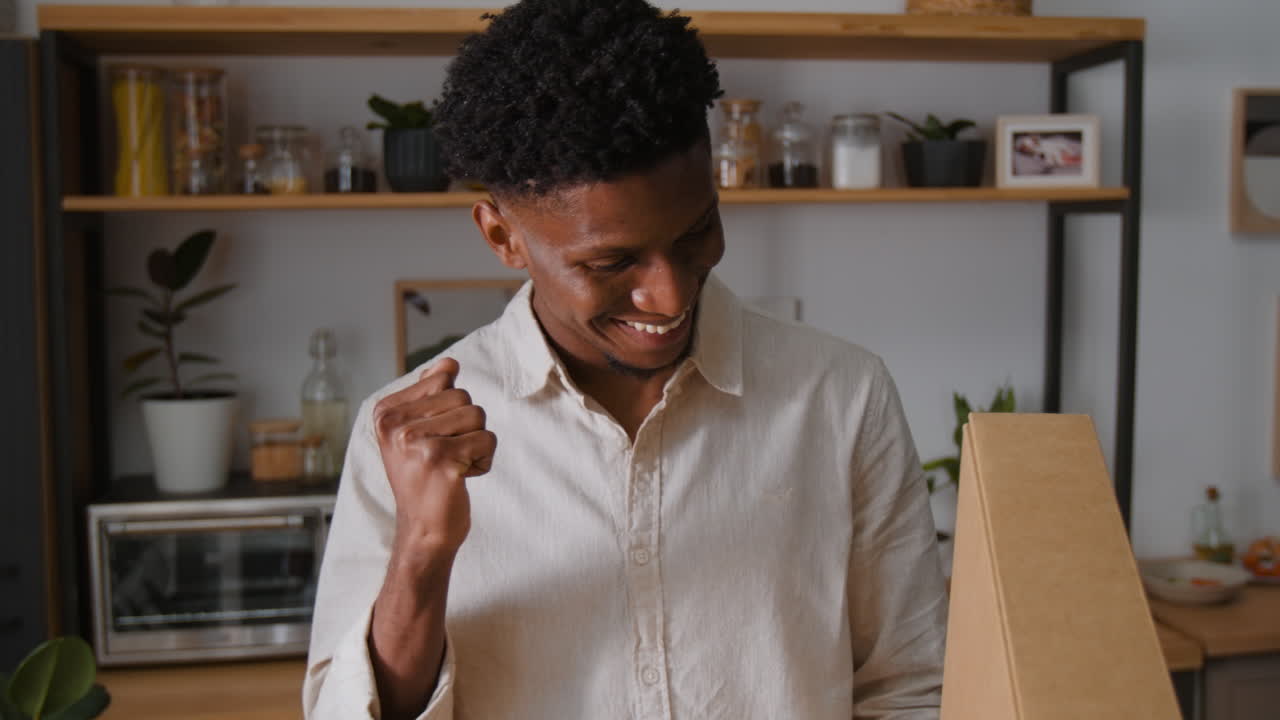 Man holding a box in a kitchen