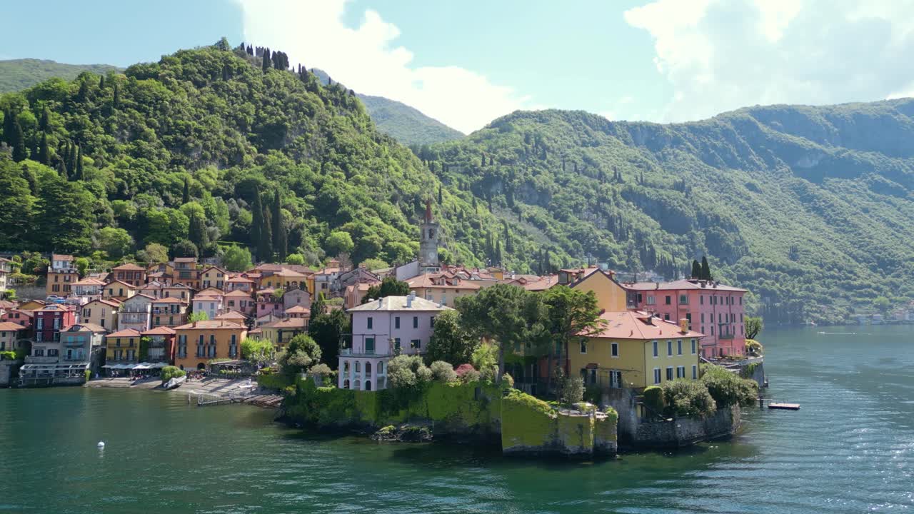 Overhead view of Varenna, highlighting the lakeside church, vibrant streets, peaceful waters, and majestic mountains in the background