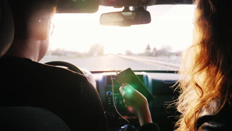 a man and a woman travel by car in the rays of the sun