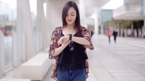 young woman checking her wristwatch
