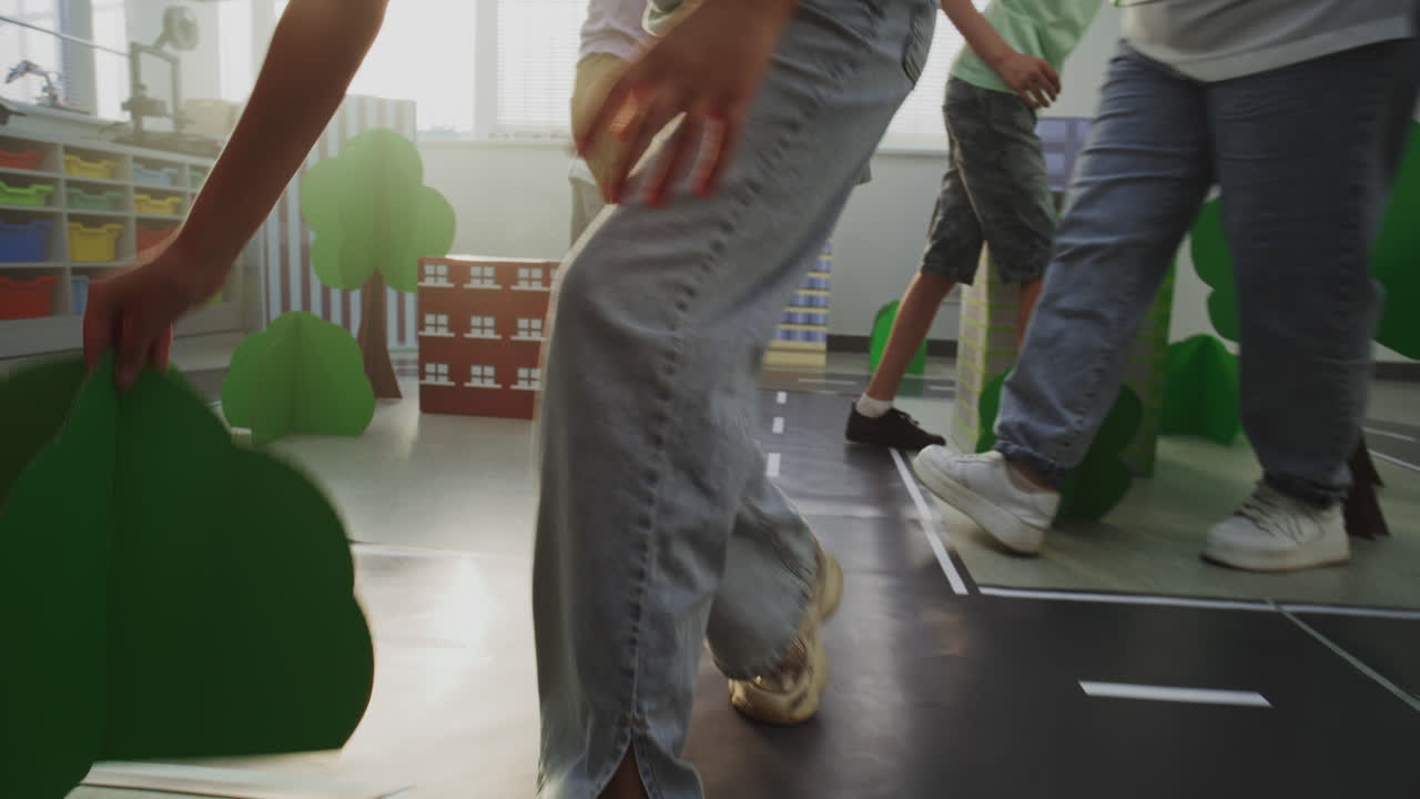 Low Angle Shot of Smart Young Kids in Hardhats Creating Interactive Urban Planning