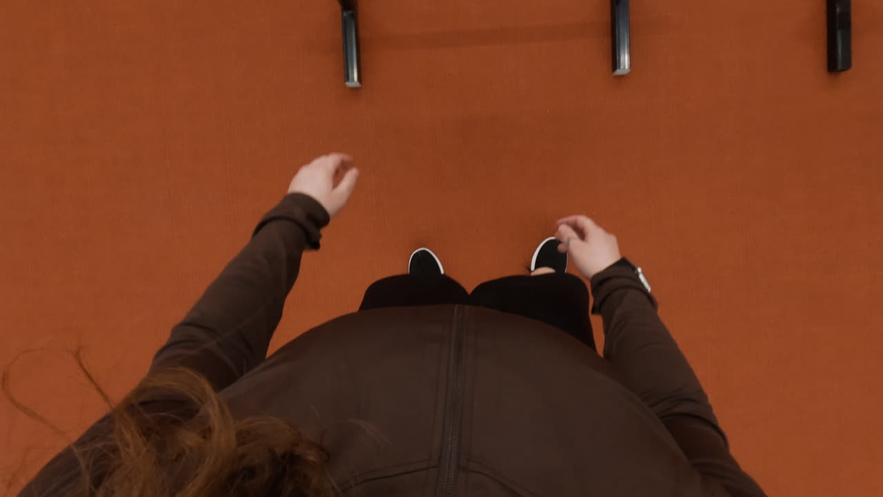 First-person perspective of feet and gym equipment during a workout