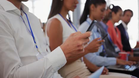 Audience-at-a-business-conference-using-phones-and-computers