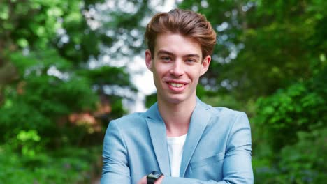 Portrait-Of-Stylish-Man-Wearing-Jacket-Standing-In-Park