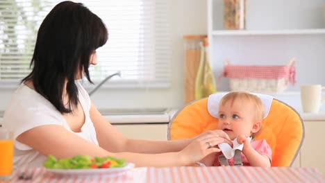 young mother feeding her daughter